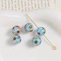 Detailed view of 10mm light blue polka dot handmade glass beads for jewelry making - Sky Blue