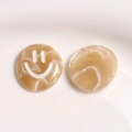 Close-up of marble pattern resin charms with smiley face for DIY hair accessories - Light Coffee White Glitter