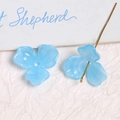Detailed macro view of light blue acrylic tulip flower beads for DIY jewelry crafting - Blue