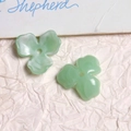 Macro shot of light green tulip-shaped acrylic bead with a marbled emerald texture - Green