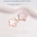 Macro detail of glittery star-shaped resin charms with aurora iridescent finish - Light Pink