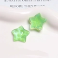 Close-up of glittery lime green resin star charms for DIY earring and hair jewelry making - Dark Green
