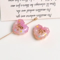 Detailed view of pink resin hearts with gold bows and glitter for DIY jewelry making - Rose Red