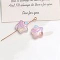 Detailed macro shot of rainbow resin star charms with tiny yellow hearts for DIY jewelry - Light Purple