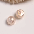 Macro detail of champagne pink pearl beads for DIY earrings with smooth pearlescent finish - 1 Piece / Light Orange