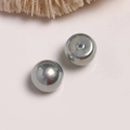 Macro shot of silver metallic round beads with center hole for DIY jewelry making - 1 Piece / Gray