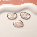 Close-up of pink pearlescent resin pendants with white bows in a ceramic dish - Silver Frame Pink Bow