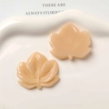 Macro detail of resin maple leaf charms showing front texture and flat back for DIY - Light Coffee