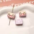 Close-up of pastel resin backpack charms with gold clasps for DIY jewelry making - Light Purple