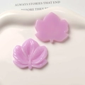 Macro shot of purple maple leaf resin charms showing translucent texture for DIY jewelry - Purple