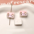 Detail view of resin backpack pendants with horizontal holes for DIY earring making - White