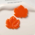 Detailed view of orange maple leaf resin charms with veins for DIY jewelry - Orange