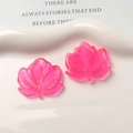 Detailed view of two pink resin maple leaf charms for DIY earrings and crafts - Rose Red