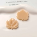 Detailed macro view of apricot maple leaf resin charms showing front and back texture - Beige