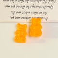 Close-up of orange translucent resin bear charms for DIY jewelry making and crafts - Half Drilled / Yellow
