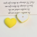 Detail of matte macaron heart-shaped acrylic beads with pre-drilled holes for DIY jewelry - 1 Piece / Turmeric