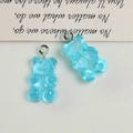Detailed view of blue translucent resin gummy bear pendants with silver metal rings - Blue