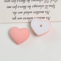 Macro view of matte heart-shaped acrylic beads with center holes for DIY jewelry making - 1 Piece / Pink