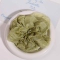 Detail of light green chiffon scrunchie with ruffled edges on a white ceramic tray - Army Green