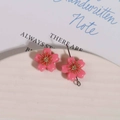Detailed macro view of pink resin cherry blossom pendant with golden flower stamens - 1 Piece / Rose Red