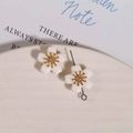 Detail of white ceramic flower earrings with gold stamens on a minimalist display tray - 1 Piece / White
