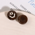 Macro shot of brown marble-textured resin round bead with a white smiley face print - Marble Pattern Smiley (Black Brown) / Black Brown