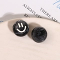 Detailed macro view of black and white marble resin beads featuring a cute smiley face design - Black