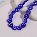 Detailed close-up of 14mm deep blue translucent glass beads with white smiley faces - Smile Face Style / 1 Piece / Dark Blue
