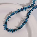 Detalle de cuentas azules en forma de estrella con textura de pintura al óleo en un plato - Estilo 14 Salpicadura Azul Lago / 1 Tira (aprox. 36 piezas)