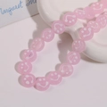 Macro shot of 14mm pink translucent round beads with white smiley faces for DIY jewelry - Smile Face Style / 1 Piece / Pink