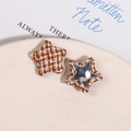 Macro view of star-shaped houndstooth fabric patches with metallic back for DIY - Brown