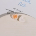 Detailed view of DIY resin heart charms with cute contrast bow accents in a white dish - Orange