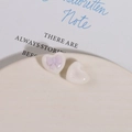 Macro detail of resin heart charms with purple bow relief for DIY jewelry making - Purple
