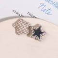 Detail of tweed star-shaped fabric buttons with metallic mirror inserts for DIY crafts - White