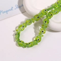 Detailed view of green fish-shaped ceramic beads with yellow polka dots for DIY jewelry - Green Fish With Yellow Dots (No. 2)