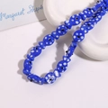 Detail of blue ceramic fish bead with white polka dots for DIY jewelry making - Dark Blue Fish With White Dots (No. 3)