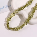 Macro shot of green fish-shaped ceramic beads with hand-painted polka dots for DIY jewelry - Light Green Fish With White Dots (No. 4)