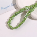 Close-up of green ceramic fish beads with white polka dots for handmade jewelry crafts - Grass Green Fish With White Dots (No. 7)