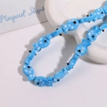 Macro shot of light blue ceramic fish beads with white polka dots for DIY jewelry making - Clear Blue Fish With White Dots (No. 14)