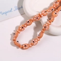 Detail shot of orange ceramic fish beads with white polka dots for jewelry making - Vibrant Orange Fish (No. 16)