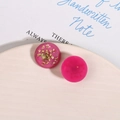 Macro shot of pink resin charms with embedded dried flowers and glitter for DIY earrings - Rose Red