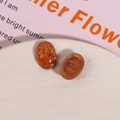 Macro detail of oval amber resin cabochons with gold foil texture for DIY jewelry making - 1 Piece / Earth Orange