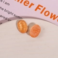Macro detail of oval orange resin earrings with shimmering gold sand texture - 1 Piece / Orange Pink