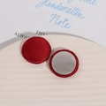 Macro detail of red satin fabric round buttons with silver metal back on ceramic plate - Red Satin (D02—4—14) / Red
