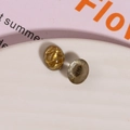 Macro detail of oval glitter resin charms with gold foil flakes for DIY jewelry - 1 Piece / Brown