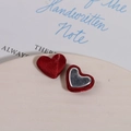 Close-up of red silk heart buttons and silver magnetic metal DIY jewelry accessories - Red