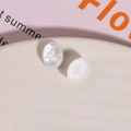 Macro shot of oval white resin charms with iridescent pearlescent finish for DIY jewelry - 1 Piece / White