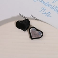 Detailed macro view of black silk and silver mirror heart buttons for DIY jewelry making - Black