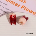 Macro detail of 17x30mm spooky resin tooth charm with realistic eyeball and blood splatter - Bloody Tooth Eyeball (No. 2)