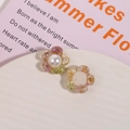 Macro detail of resin flower charms with dried petals and pearls for jewelry making - Pink